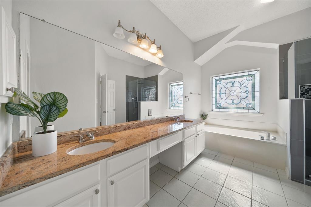 Beautiful updated primary bathroom with granite counters