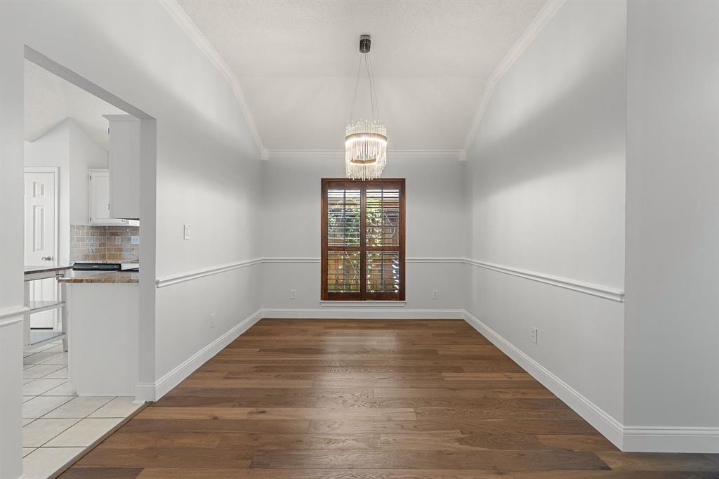 Dining room with wood shutters and gorgeous light fixture