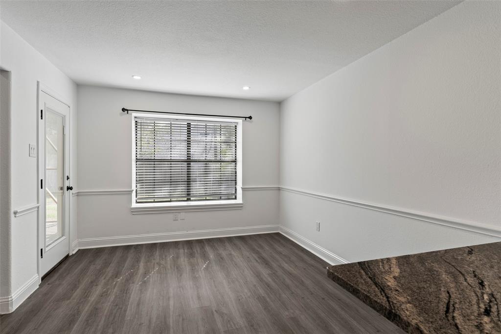 Neutral wall paint featuring chair rail molding, wood-finish flooring, recessed lighting, and a window with horizontal blinds