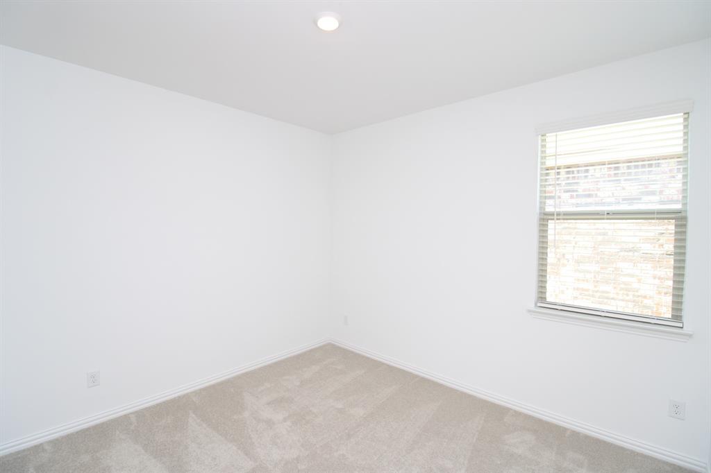Neutral-toned wall paint, plush carpeting, recessed lighting, and a single-hung window featuring horizontal blinds