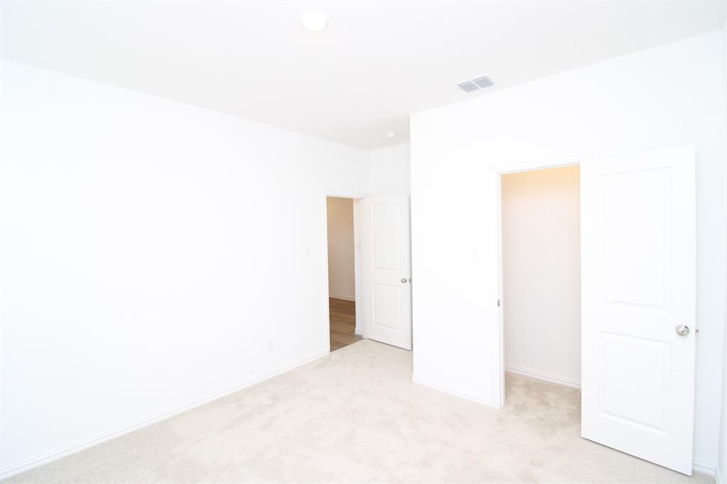 Neutral-toned carpeting, two-panel interior doors, and closet storage