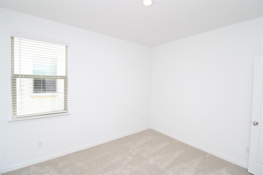 Neutral-toned carpeting, white walls, recessed ceiling lighting, and a single-pane window with horizontal blinds