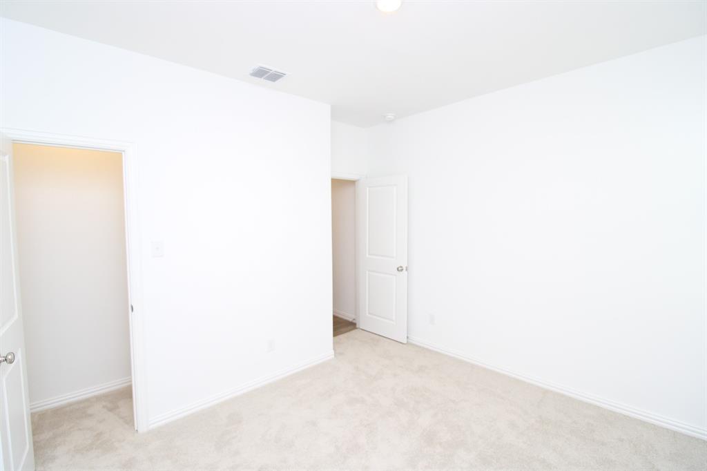 Neutral interior featuring light-toned wall-to-wall carpeting and solid-core interior doors with metallic lever hardware