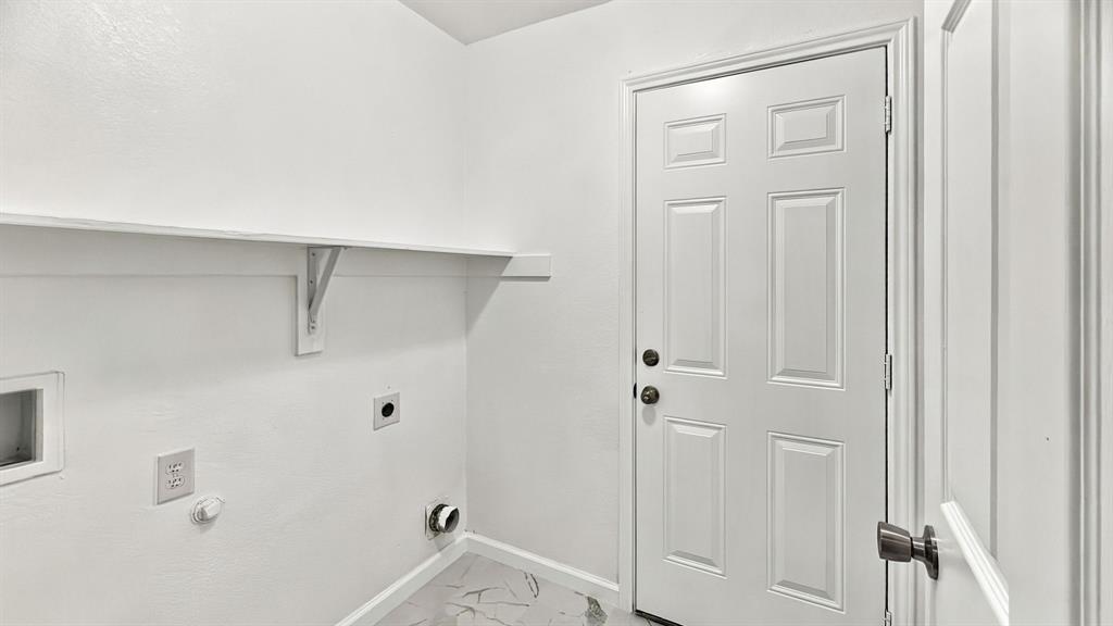 Private backyard featuring a wood privacy fence, concrete patio, grass lawn, and mature trees