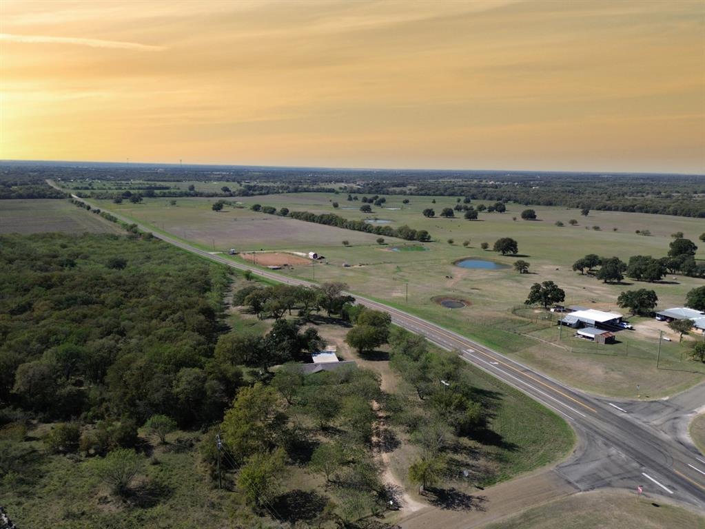Expansive acreage featuring mature tree clusters, open pasture land, and multiple natural ponds