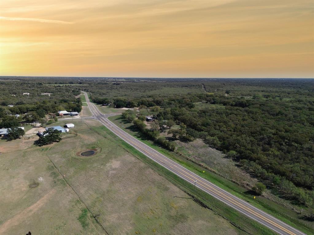 Aerial perspective of expansive acreage featuring native vegetation, established trees, and natural terrain