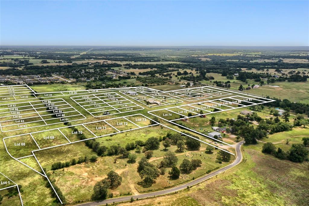 Aerial perspective of expansive residential acreage featuring defined lot boundaries, open terrain, mature trees, and paved thoroughfares Aerial perspective of expansive residential acreage featuring defined lot boundaries, open terrain, mature trees, and paved thoroughfares