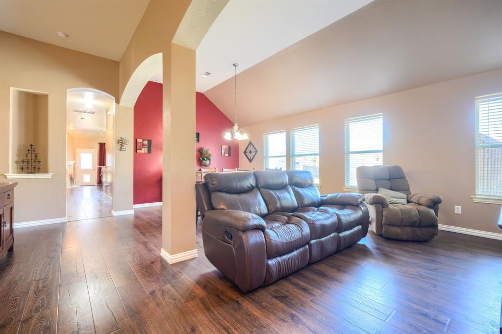 Vaulted ceilings, wood-finish flooring, architectural arched openings, and a built-in recessed wall niche Vaulted ceilings, wood-finish flooring, architectural arched openings, and a built-in recessed wall niche