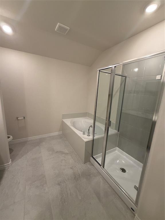 Bathroom featuring a deep soaking tub with a deck surround, a separate glass-enclosed shower, large-format tile flooring, and recessed ceiling lighting