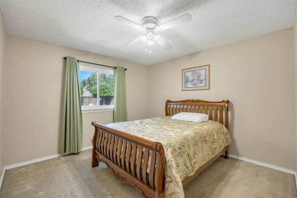 Neutral interior space featuring carpeted flooring, a ceiling fan with integrated lighting, and a single-pane horizontal window