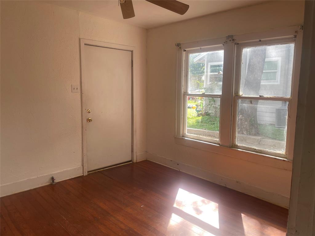 Front bedroom with exterior door to covered front porch