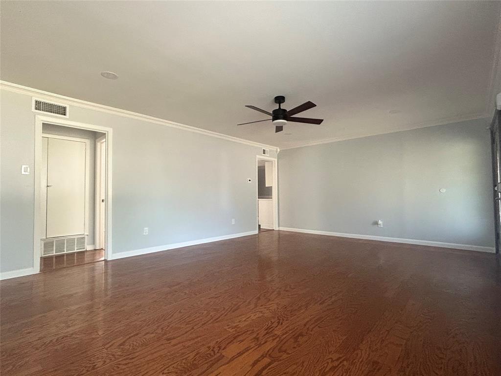 Spacious interior featuring wood-finish flooring, recessed lighting, and a dark-finish ceiling fan Spacious interior featuring wood-finish flooring, recessed lighting, and a dark-finish ceiling fan