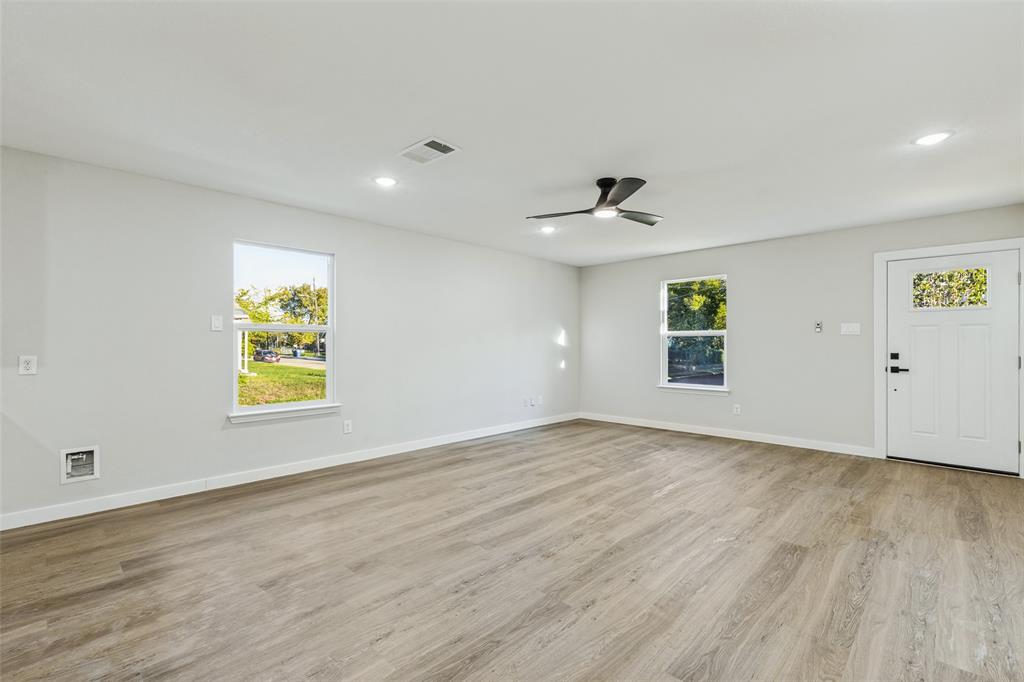 Open floor plan living room with ceiling fan