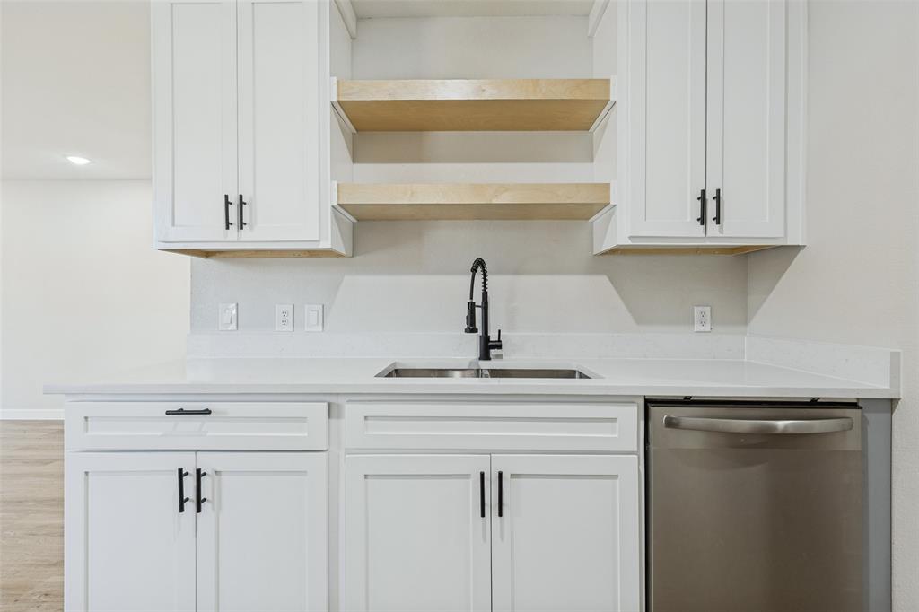 Kitchen with stainless steel dishwasher.