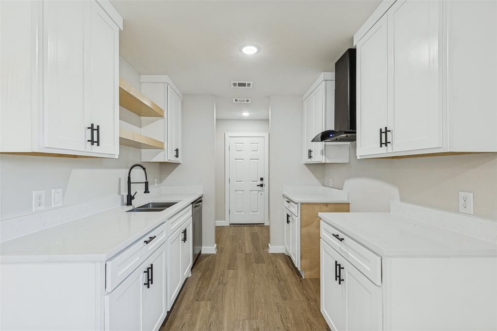 Kitchen featuring new white cabinetry and light-toned quartz. Range will be installed upon purchase!