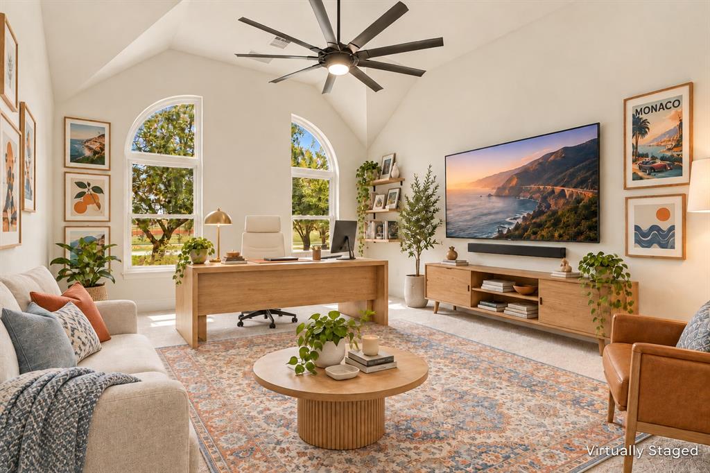 Vaulted ceilings, arched windows, and a multi-blade ceiling fan