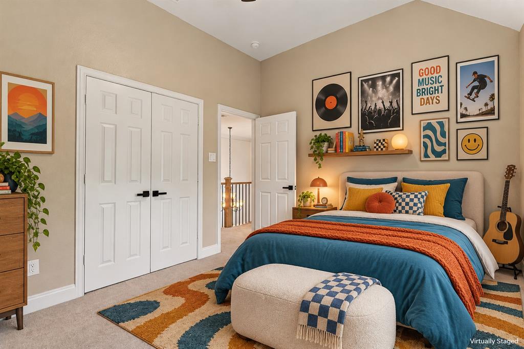 Vaulted ceilings, neutral wall tones, six-panel doors with matte black hardware, and wall-mounted wooden shelving