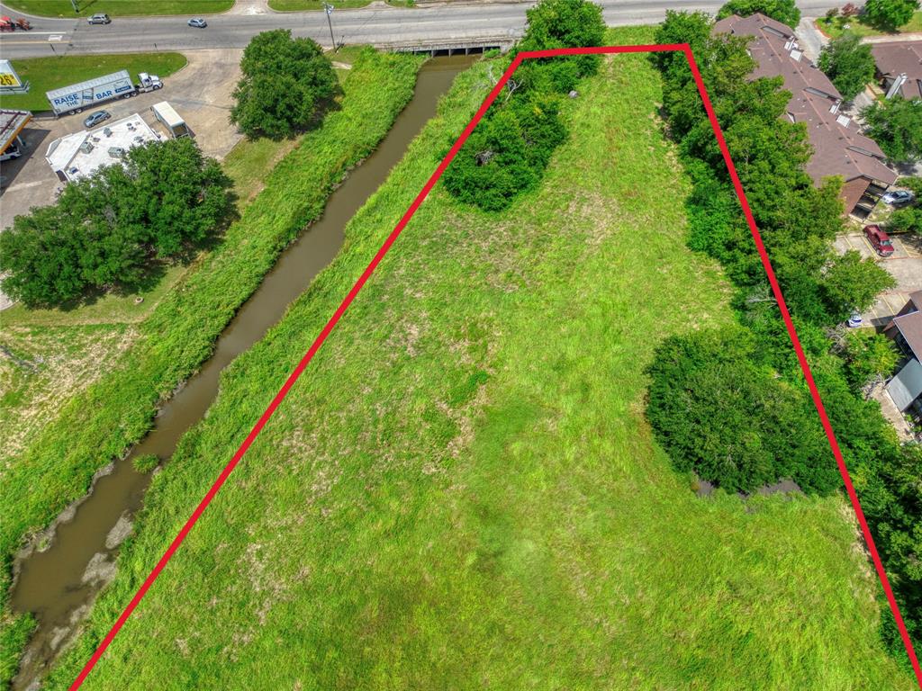 Expansive parcel of land featuring natural vegetation and clusters of mature trees