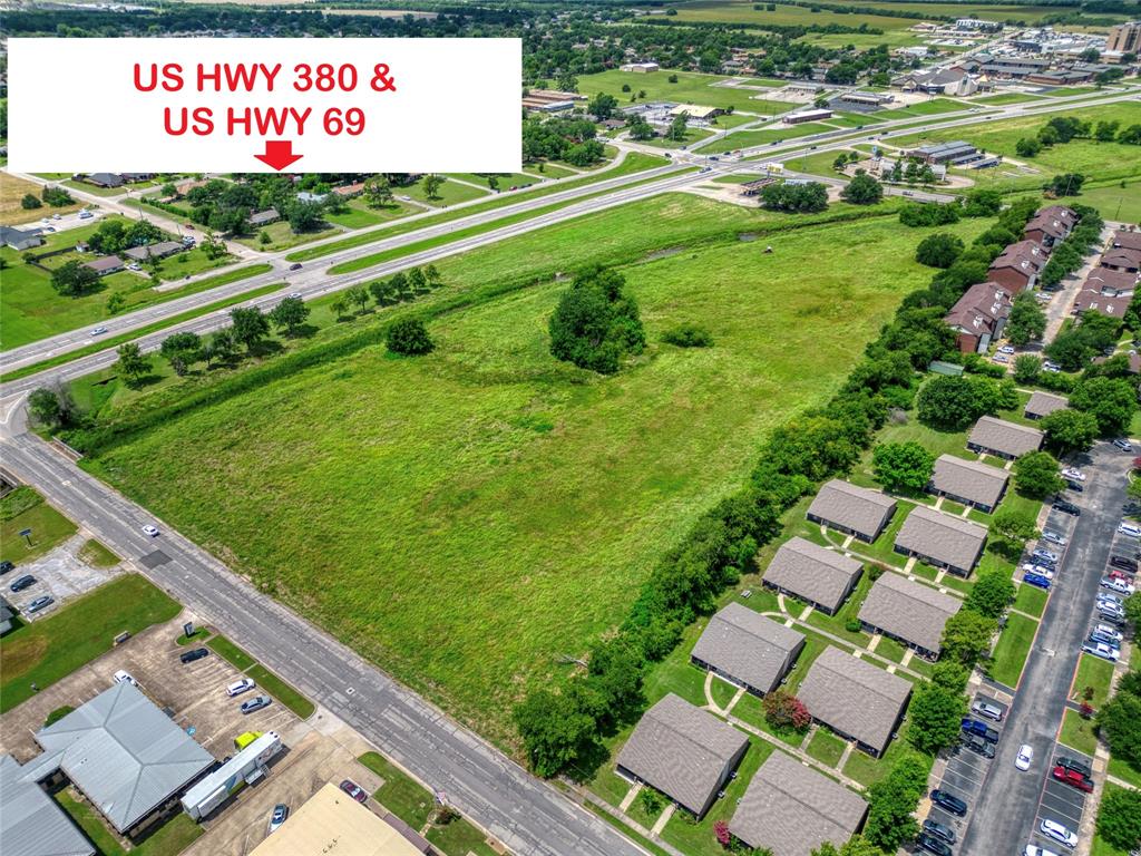 Expansive undeveloped land parcel situated at the intersection of US Highway 380 and US Highway 69, featuring prominent frontage and proximity to established thoroughfares