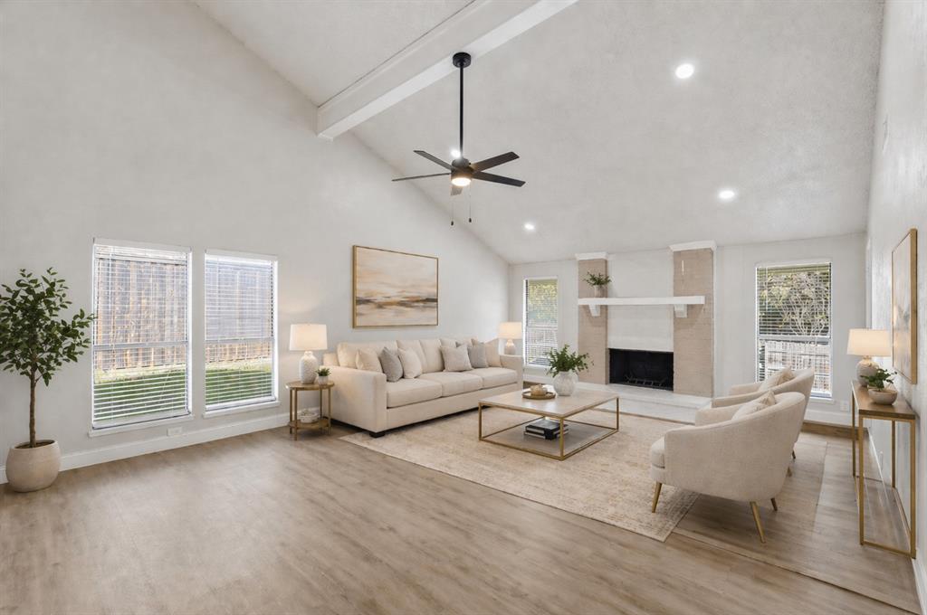 Vaulted ceilings, wood-finish flooring, recessed lighting, ceiling fan, and masonry fireplace with an integrated mantel Vaulted ceilings, wood-finish flooring, recessed lighting, ceiling fan, and masonry fireplace with an integrated mantel
