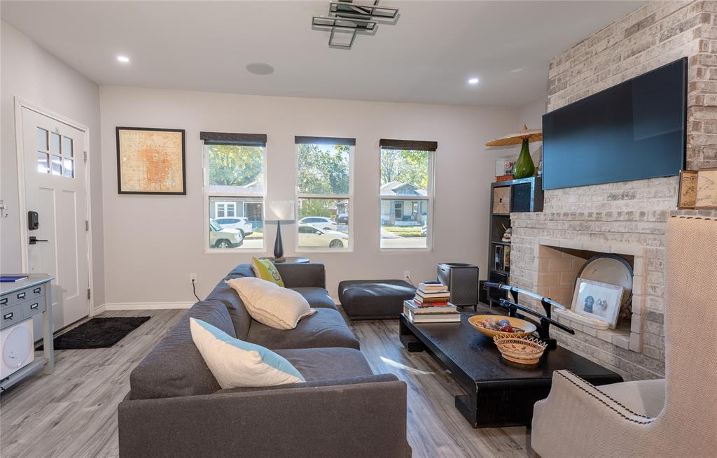 Living room with a wood-burning fireplace with Views out to a tree-lined neighborhood Living room with a wood-burning fireplace with Views out to a tree-lined neighborhood