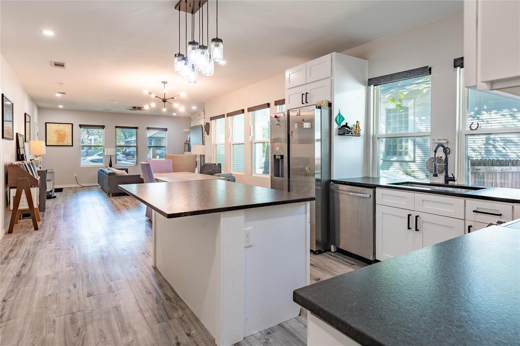 The open floor plan creates a window-lined great room with a kitchen, dining room, and living room. The open floor plan creates a window-lined great room with a kitchen, dining room, and living room.