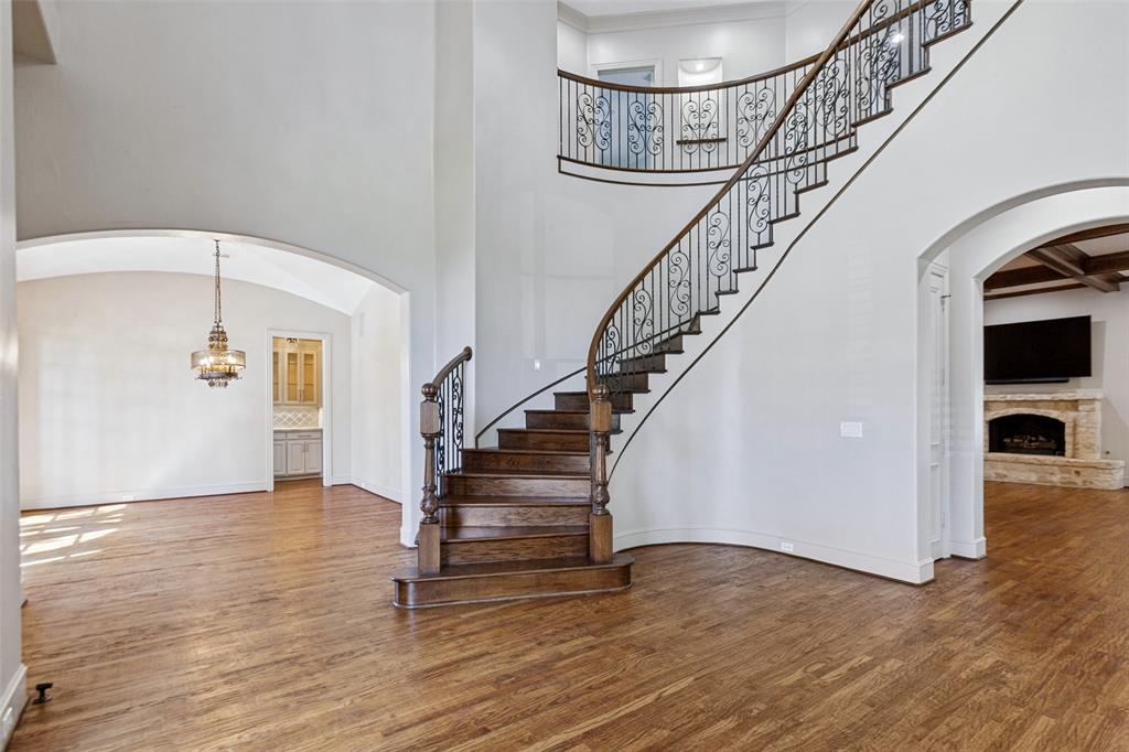 High ceilings, hardwood floors, and a graceful staircase welcome you to the interior with an open flow.
