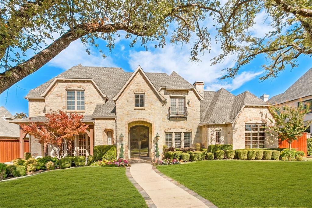 Walkway with perimeter slate leads to the covered patio with stunning, custom designed Solara front entry doors.