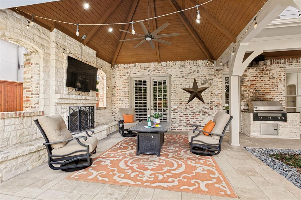 The outdoor Living Area is designed for virtual year-round enjoyment with a cedar plank roof, fireplace, TV, and Infrared Elite Grill.