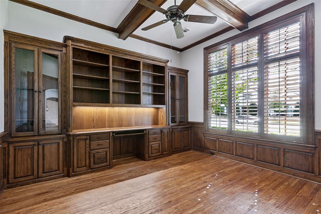 The handsome study offers privacy. many built-ins, coffered ceiling, and a separate storage room for equipment and supplies.