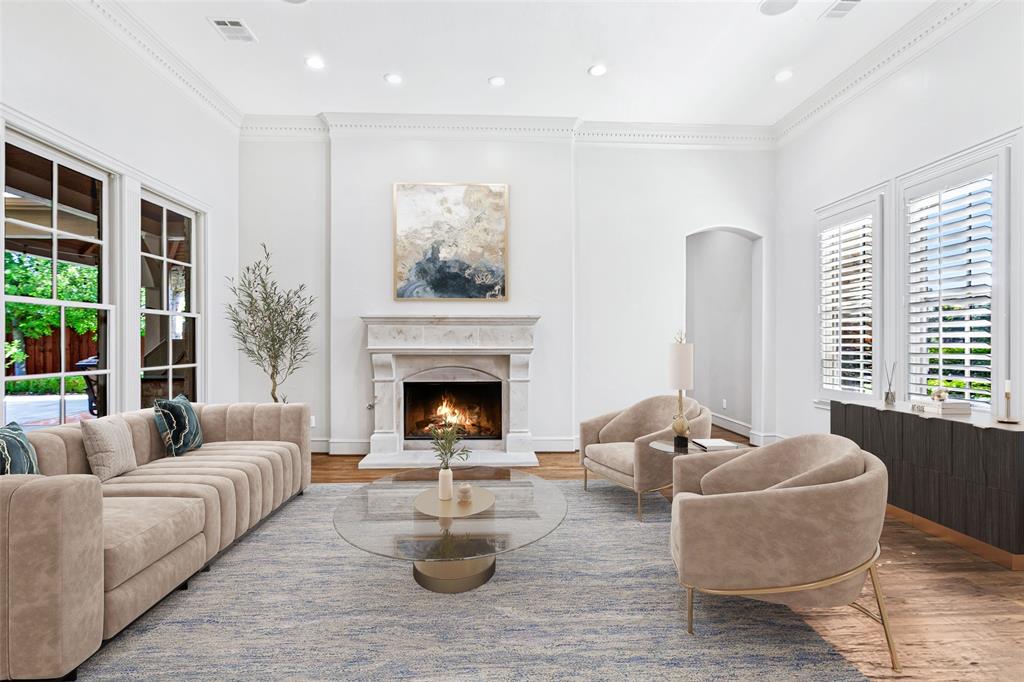 Virtually staged Living Room is to the right of the entry, bathed in light by 2 walls of windows with a fireplace as the focal point. The Study and Guest Suite are beyond.