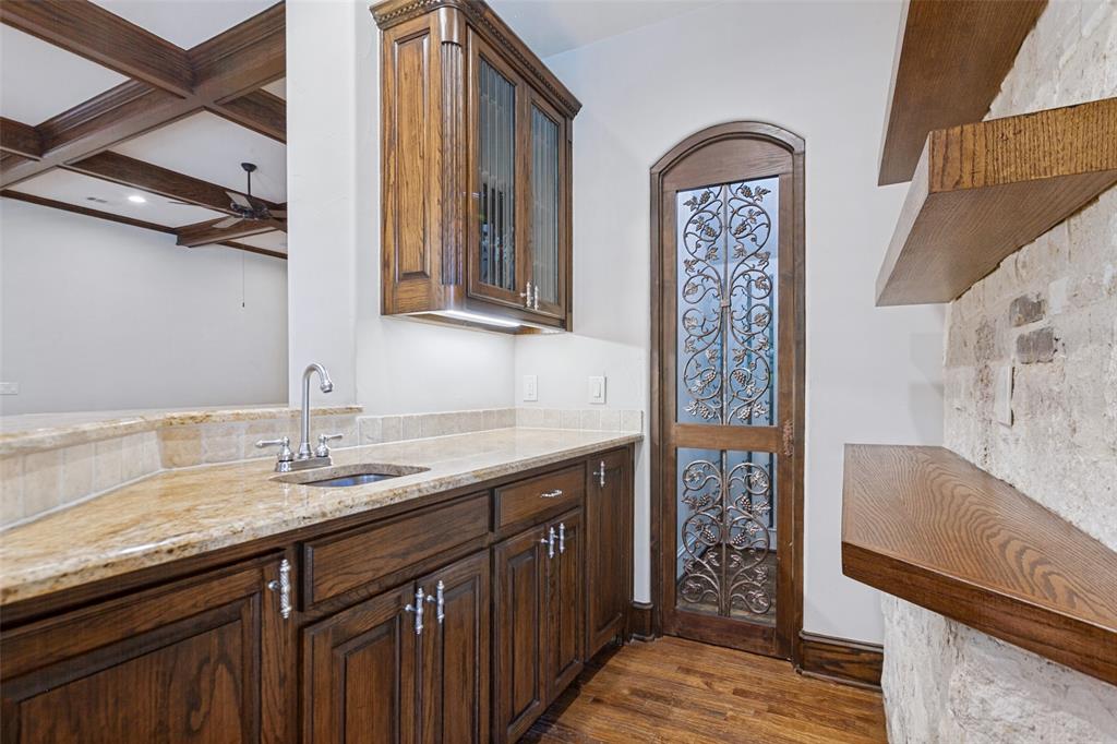 Wet Bar in the Family Room. More wine storage is behind the exquisite wood and iron door.