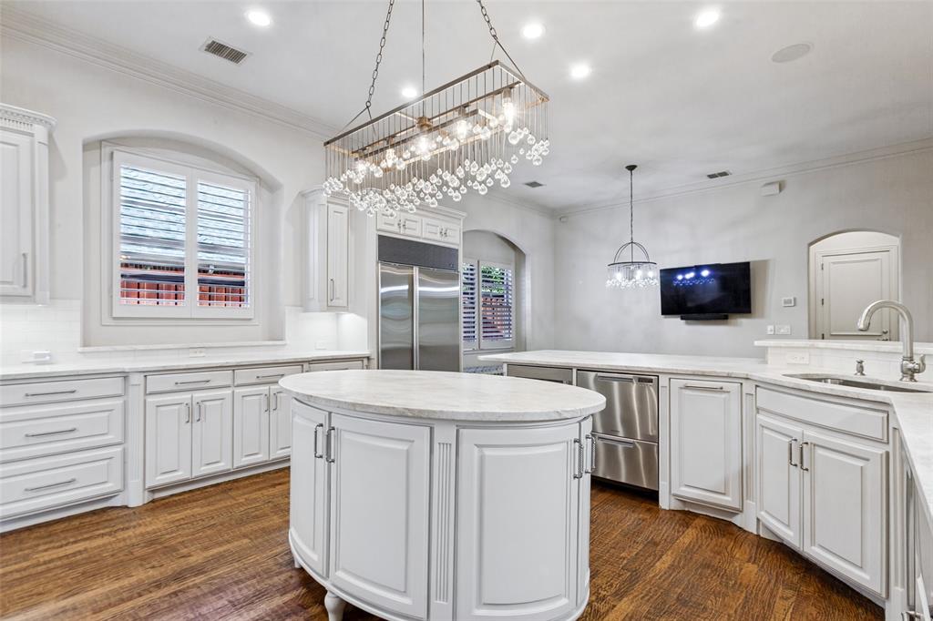 Gorgeous Taj Mahal counters and top-of-the-line appliances accent the Kitchen, including Bosch dishwasher, Bosch warming drawer, Fisher & Paykel dish drawers, Sub-Zero refrigerator/freezer, and Sub-Zero wine chiller.
