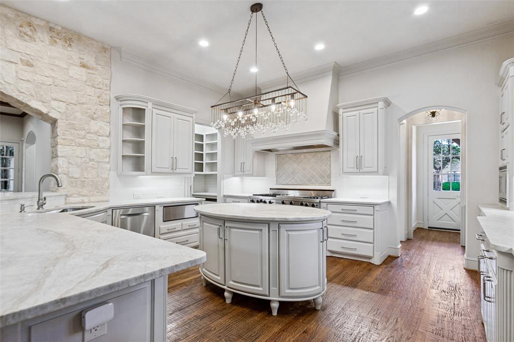 To the left rear is the pantry with abundant organized storage plus a task countertop for appliances.