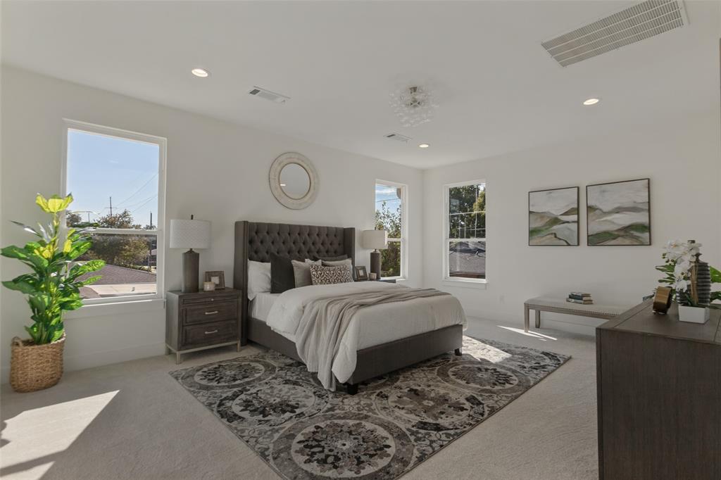 Neutral-toned carpeted flooring, recessed lighting, neutral wall paint, and multiple windows providing natural light