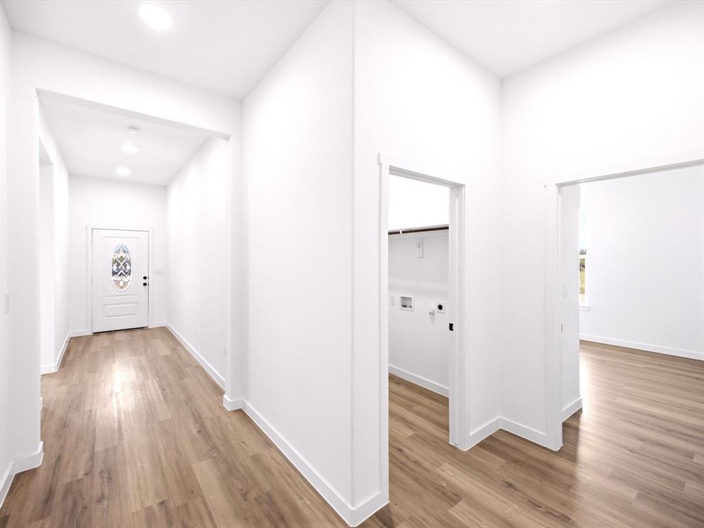 Entryway featuring wood-finish flooring, recessed lighting, and a white front door with an oval decorative glass insert