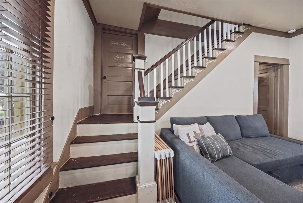 Staircase featuring dark wood-finish treads, decorative millwork accents, and a classic wood-and-white balustrade