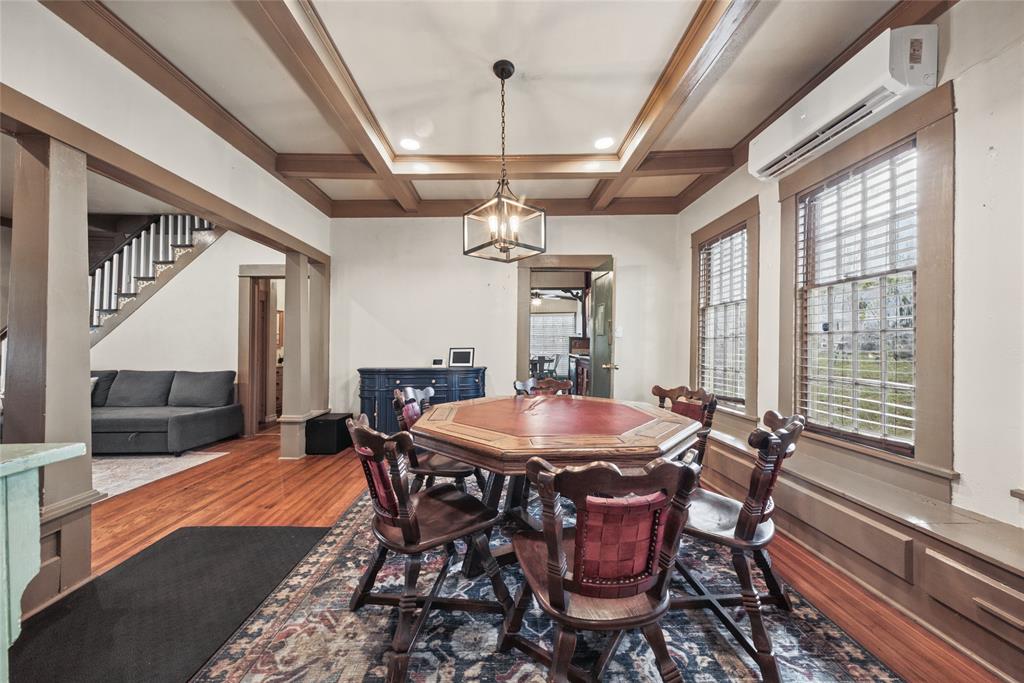 Coffered ceiling featuring recessed lighting, wood-finish flooring, and a central pendant fixture with a metal frame