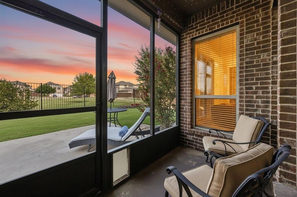 Screened-in back porch extends the living space outdoors with peaceful views of the greenbelt beyond the backyard.