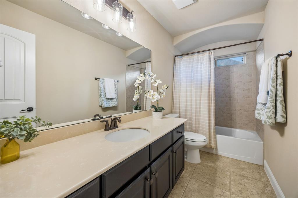 Full upstairs bathroom conveniently serves the fourth bedroom and game room.