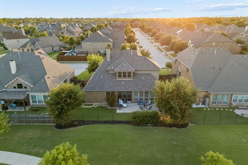Aerial view highlights the home's position along the greenbelt and the surrounding Sachse neighborhood.
