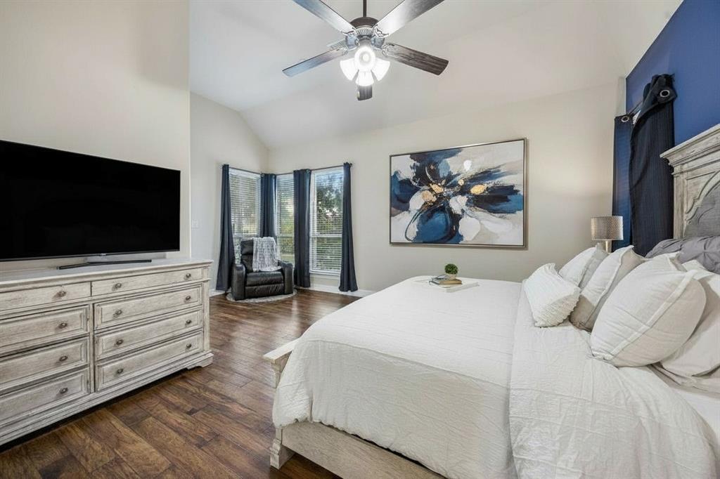 Alternate view of the first-floor primary suite highlights the room's generous size and natural light.