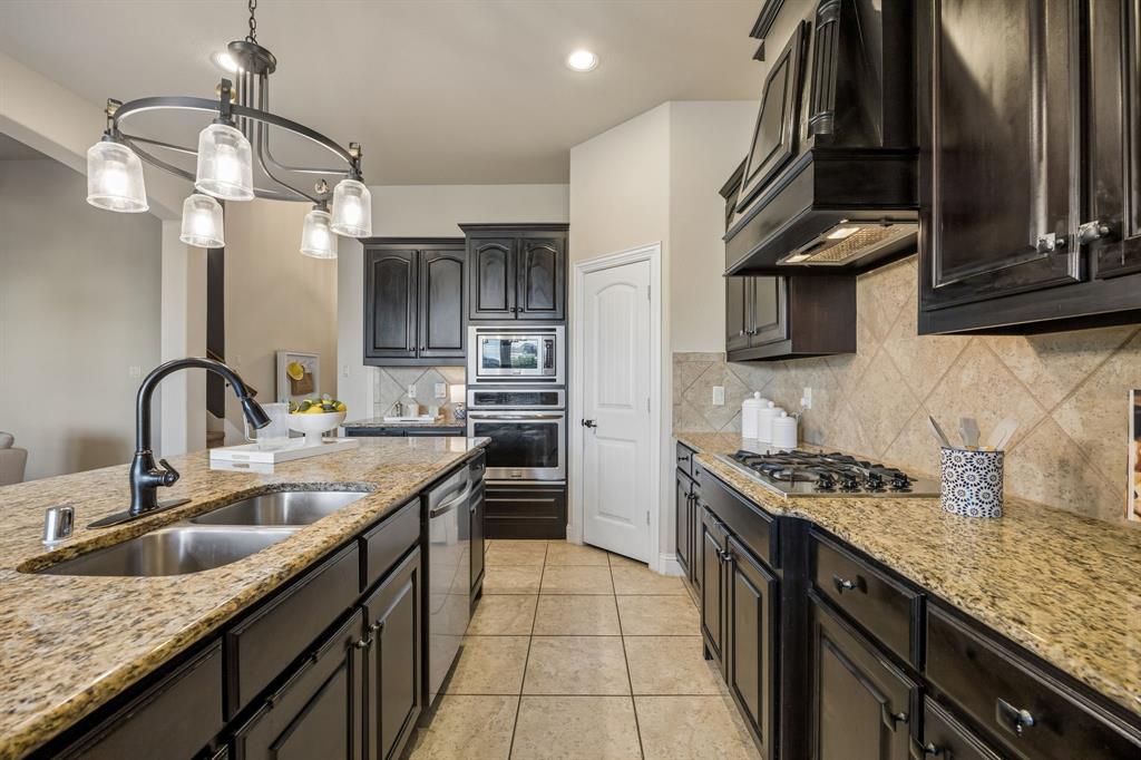 Granite countertops, stainless steel appliances, espresso cabinetry and updated lighting complete the kitchen.