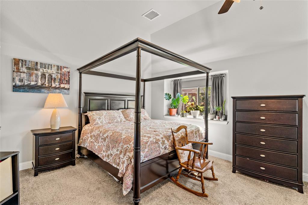 Vaulted ceilings, carpeted flooring, and a recessed window nook
