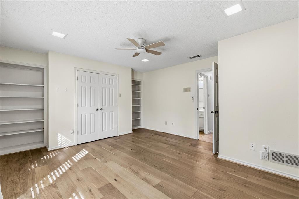 Wood-finish flooring, recessed LED lighting, ceiling fan, double-door closet, and built-in shelving