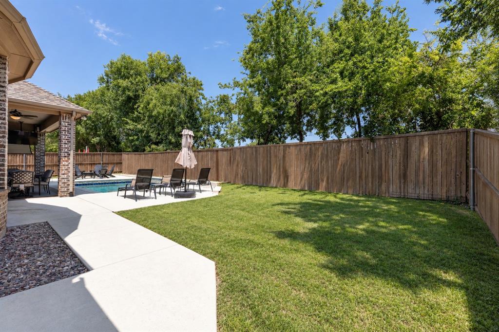 Corner lot with pool, covered patio and still a large grassy yard!
