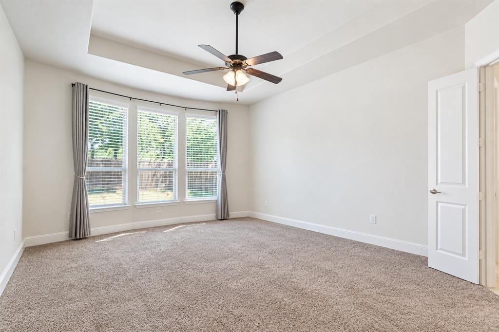 Large primary bedroom facing back yard and pool unfurnished