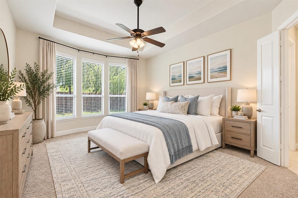 Large primary bedroom facing back yard and pool virtually staged