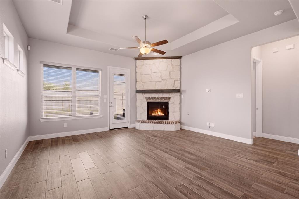 gorgeous corner stone fireplace in living