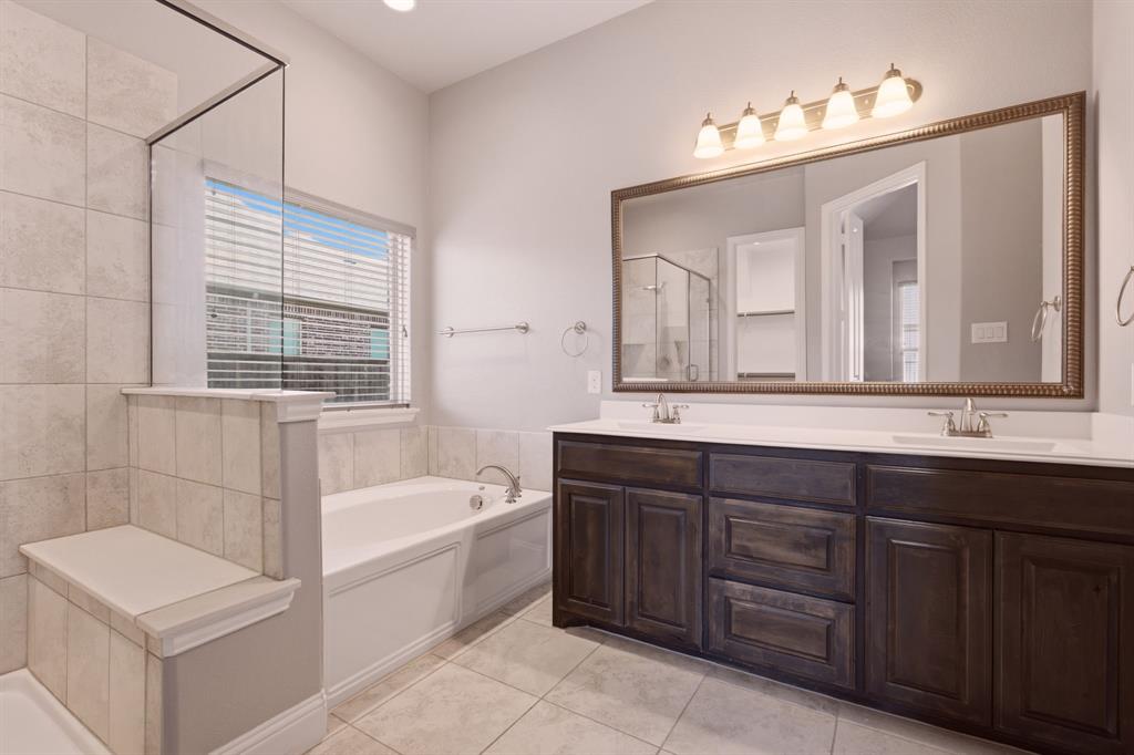 dual sinks w glass shower and soaking tub